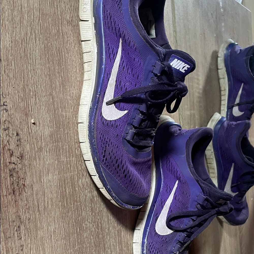 Purple women’s Nike slip on’s